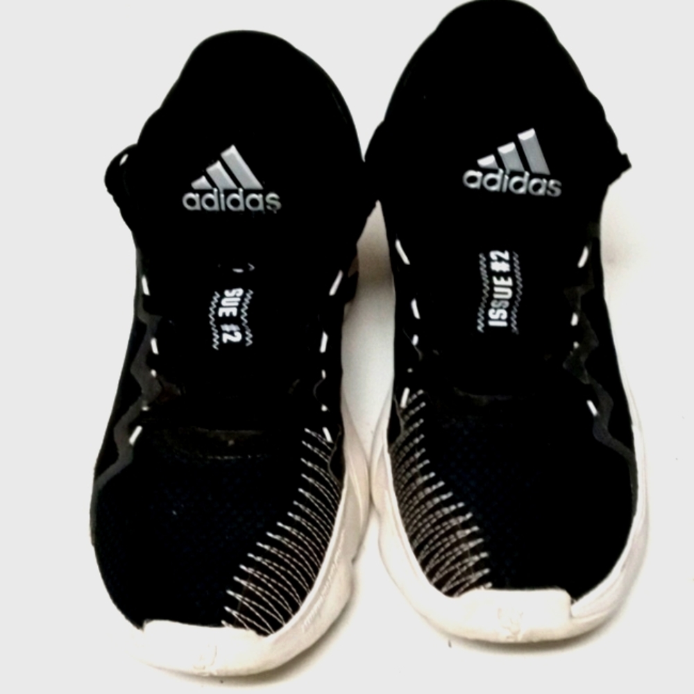A pair of black and white Adidas issuenumber # 2 tennis shoes
